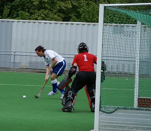 Here, the goalkeeper moves off his line to challenge the angle to his left post (holding the right post to force the shot to his left).